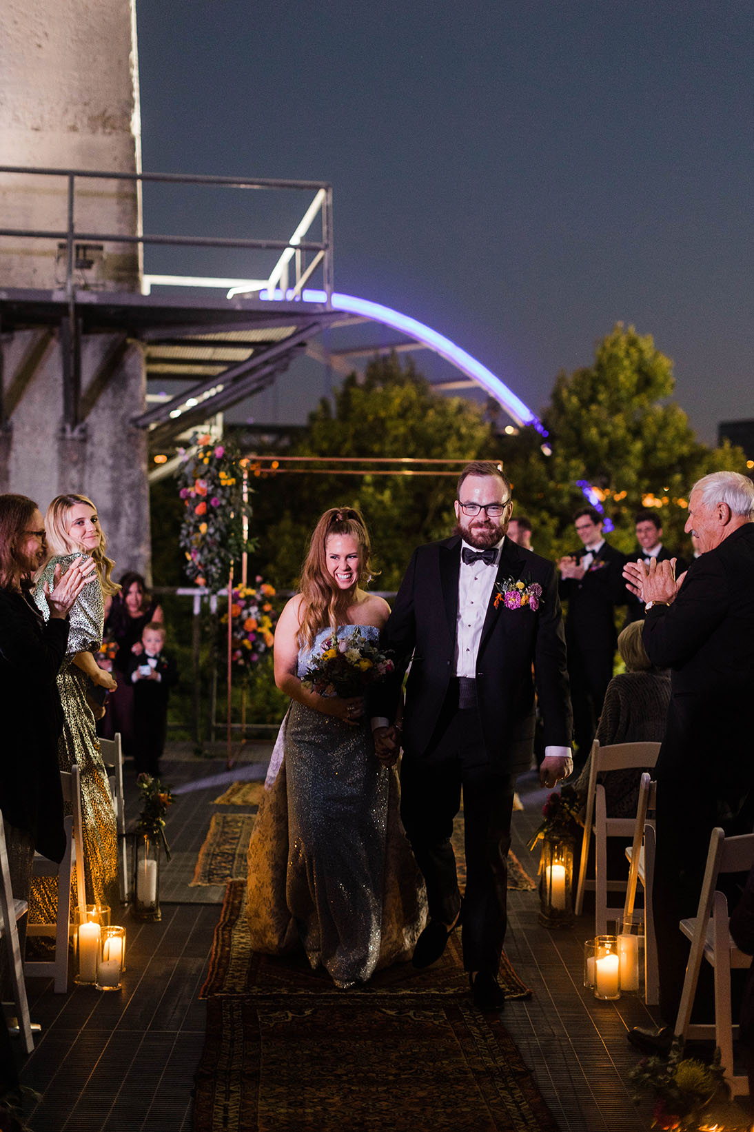 Boho wedding ceremony recessional down the riverfront at night
