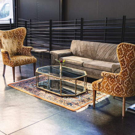 Vintage lounge area with velvet chairs and midcentury modern sofa