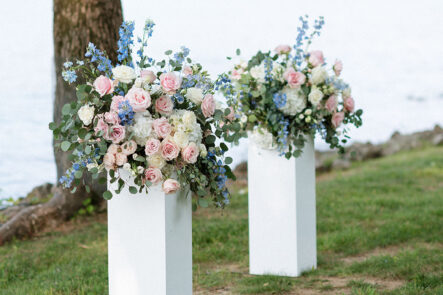 Pink and Blue Floral Arrangement on Ceremony White Pillars