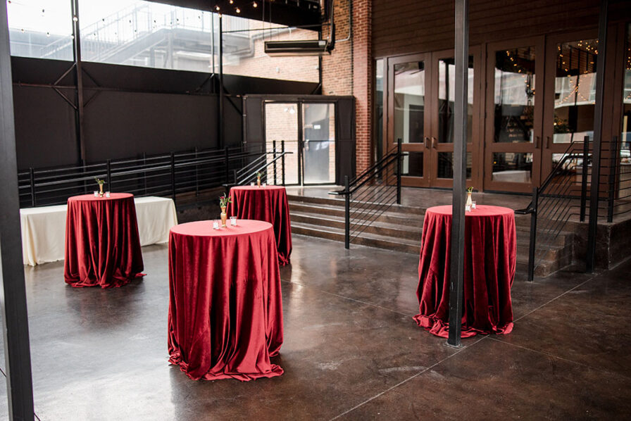 The Bell Tower patio with Red velvet Linens on Bistro Tables