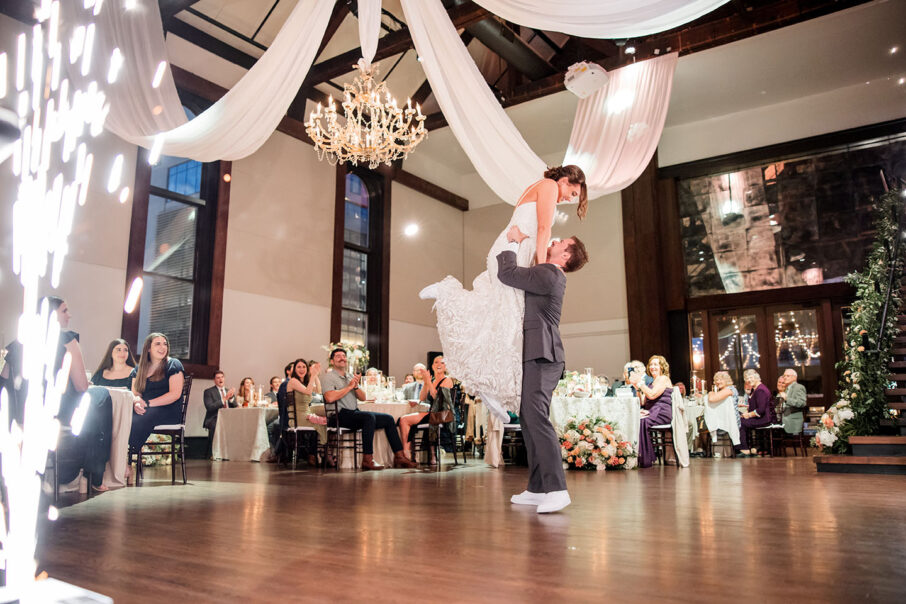 bride and groom first dance groom holding the bride in the air