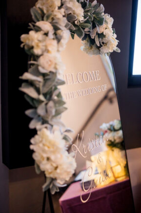 mirror welcome sign with calligraphy and florals