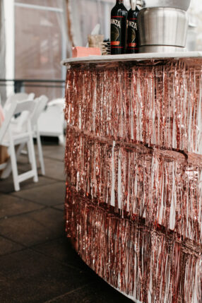 Round bar decorated with rose gold tinsel fringe