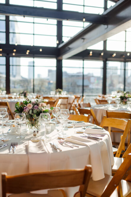 Ivory Table setting with natural wood folding chairs and floral centerpiece