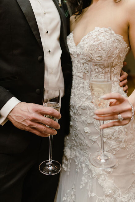 Bride and groom holding glasses of champagne