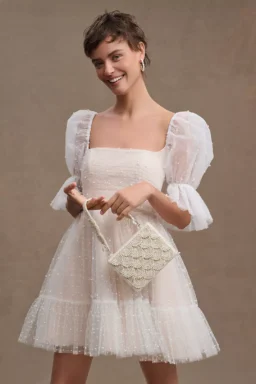 Folklore-inspired wedding reception dress with pearls and puff sleeves